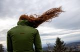 Frau steht im Wind