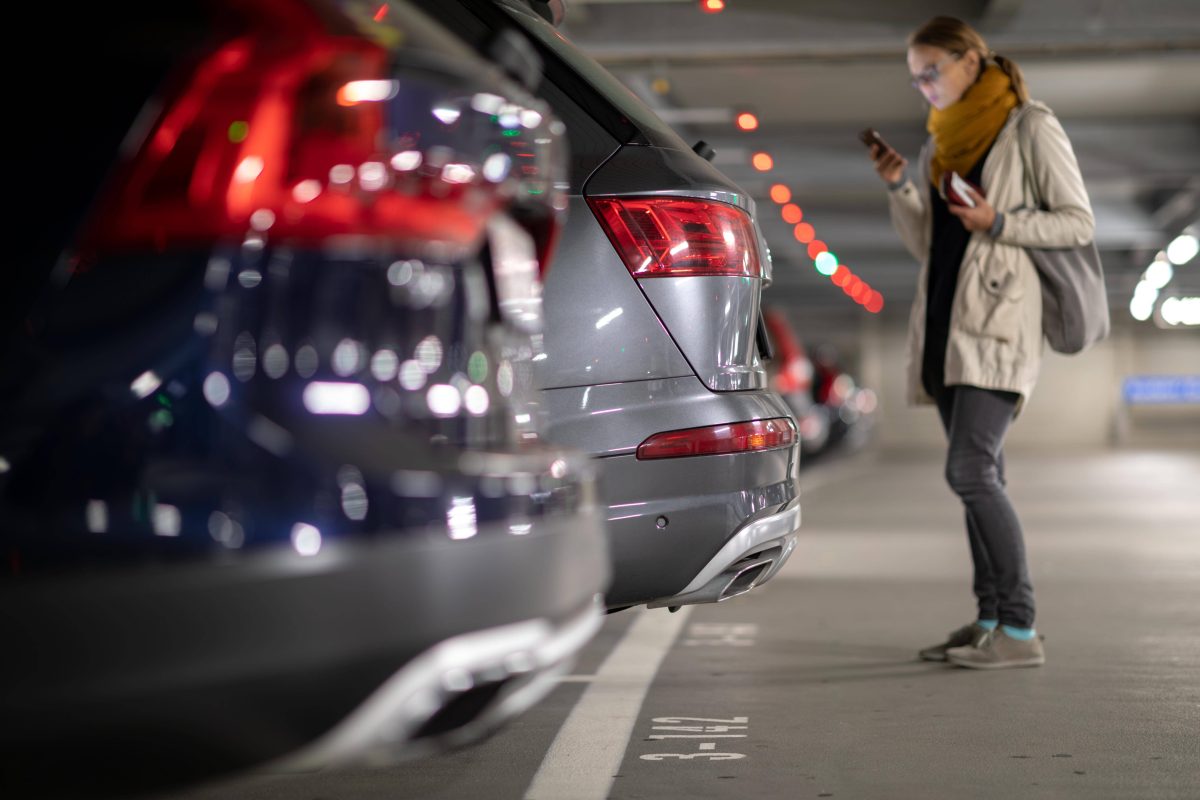 Frau im Parkhaus vor einem Auto