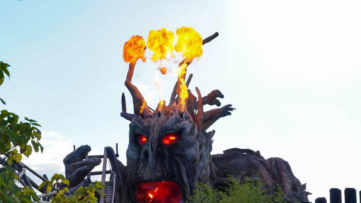 A fire-breathing monster tears out part of the track of the intense wooden roller coaster Colossos at the theme park Heide Park